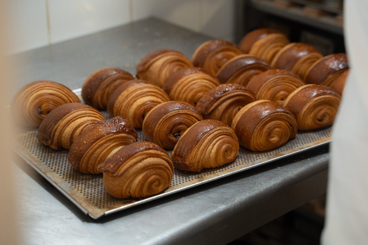 A tray of freshly baked croissants in a Berlin bakery, showcasing artisanal craftsmanship.